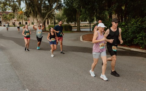 a group of people running on a road