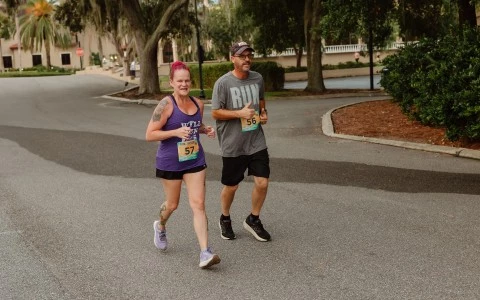 a man and woman running on a road