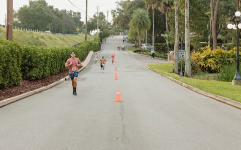a group of people running on a road