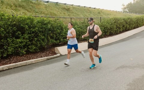 two men running on a road