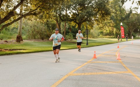 a group of men running on a road