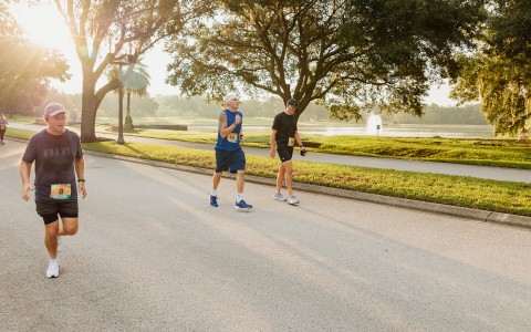 a group of men running on a road