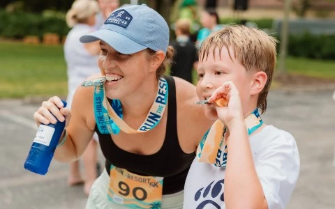 a woman and a boy wearing medals