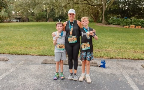 a woman and two boys posing for a picture