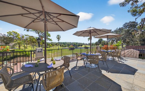 a patio with tables and umbrellas