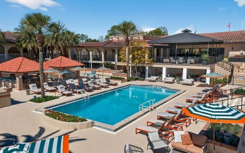 a pool with lounge chairs and umbrellas