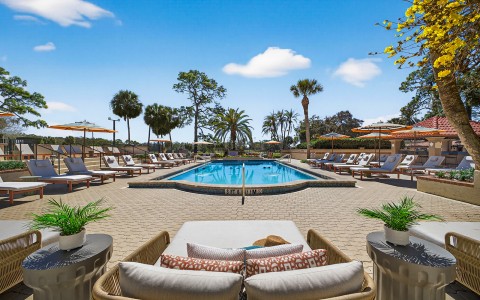 a pool with chairs and umbrellas