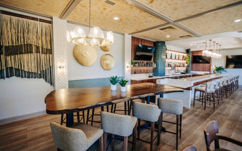 a room with a long table and chairs