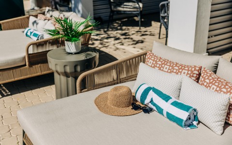 a chair with a towel and a hat on it