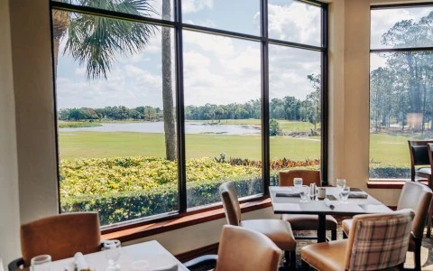 a room with a view of a golf course and a golf course