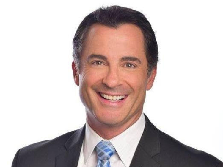 a man in a suit smiling