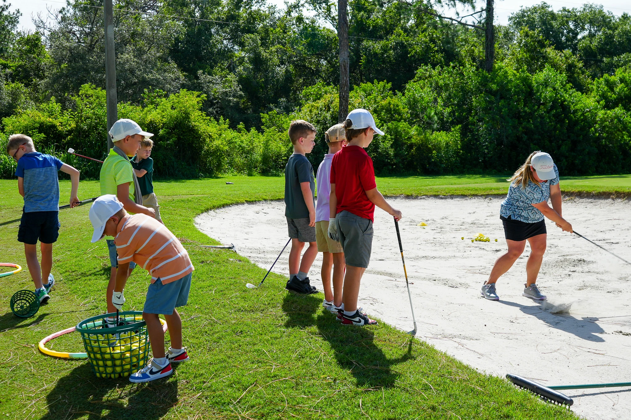 a group of kids playing golf