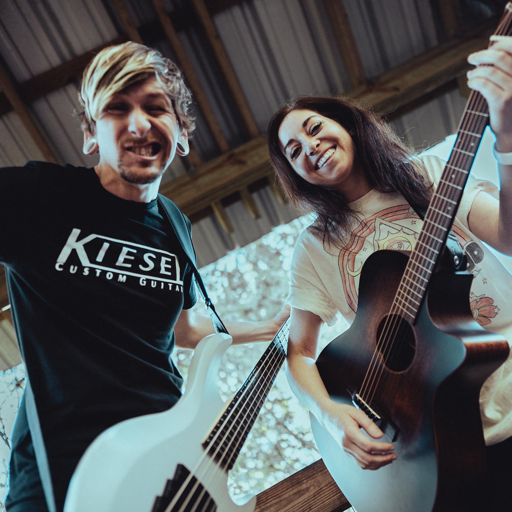 a man and woman playing guitars