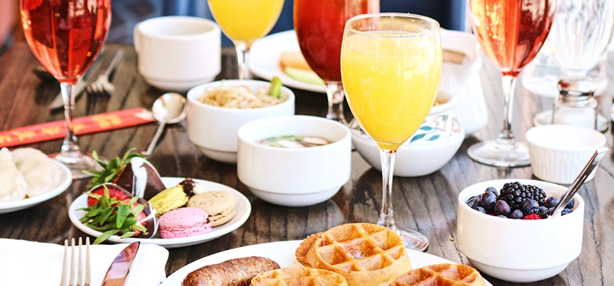 a table with plates of food and glasses