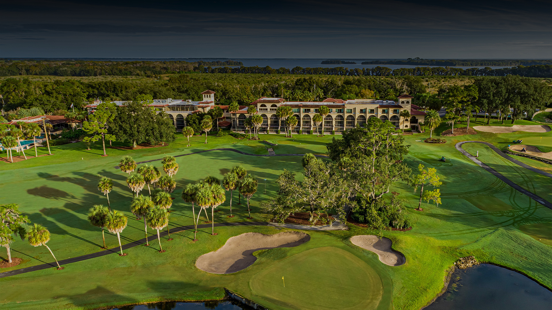 a golf course with a building and trees