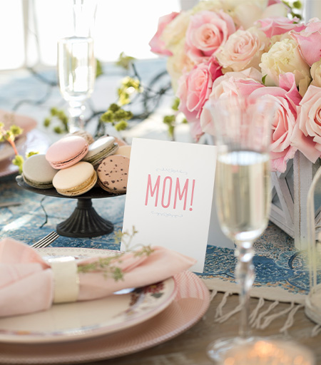 a plate with plates and glasses with a bouquet of flowers
