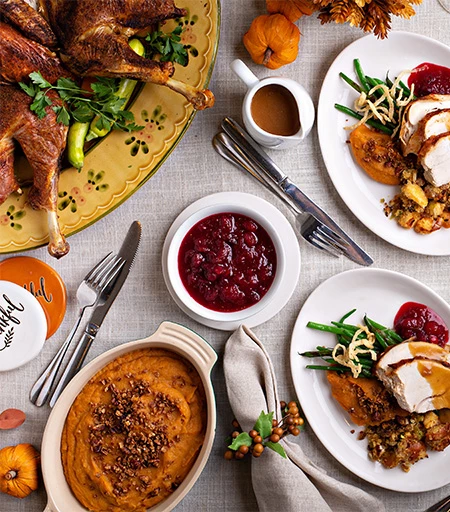 a table with plates of food and utensils