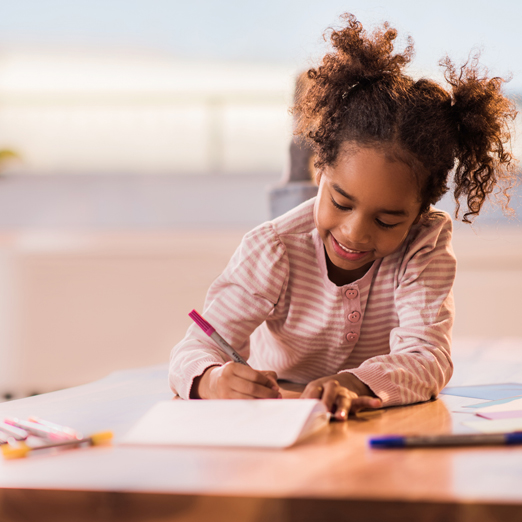 a girl writing on a book