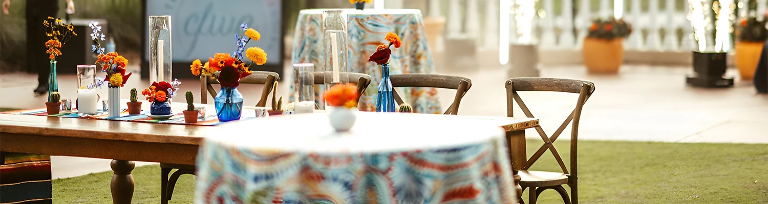 a table with a blue vase with flowers