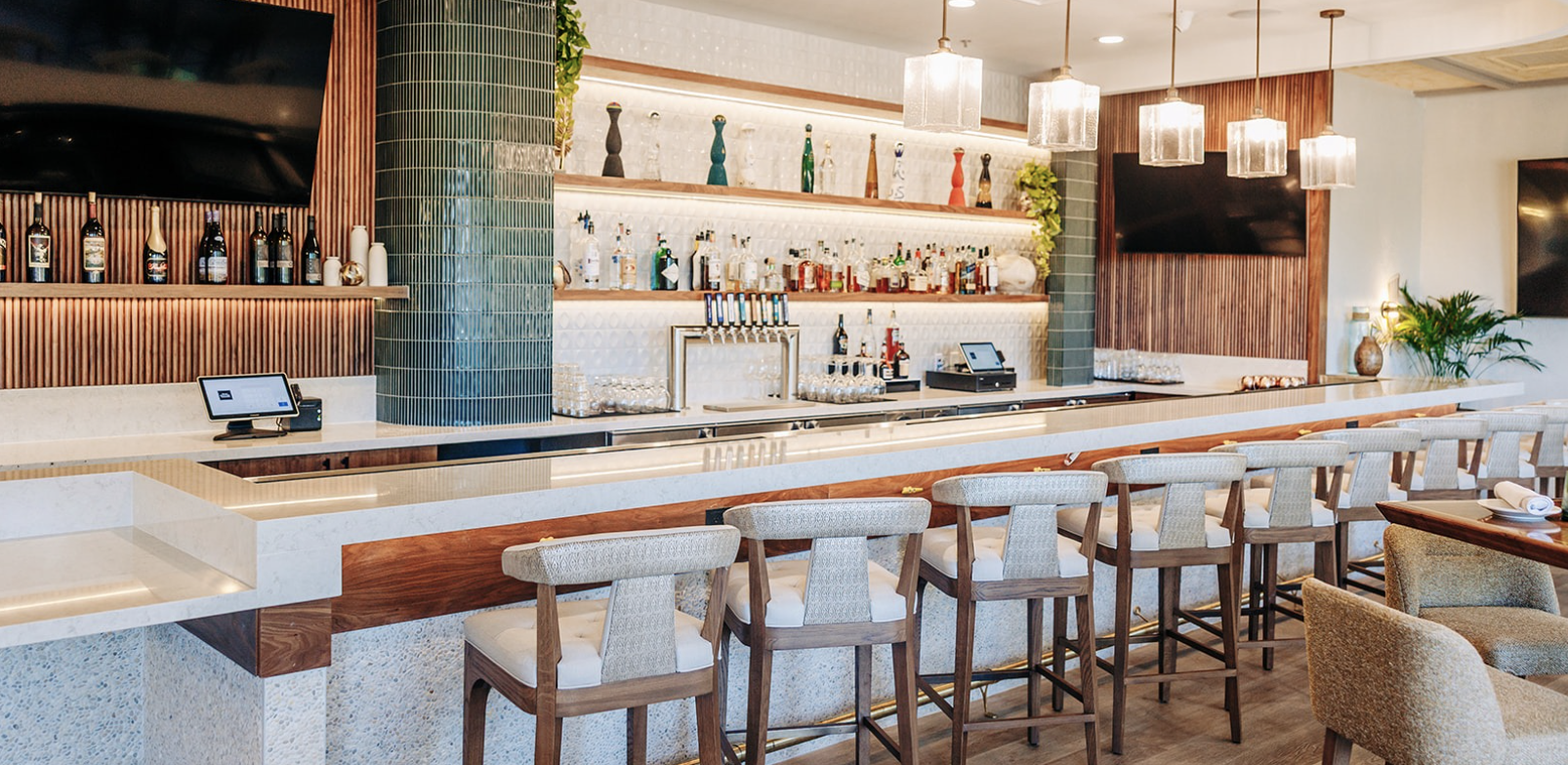 a bar with chairs and a counter