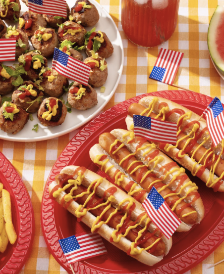 a plate of hot dogs and a watermelon