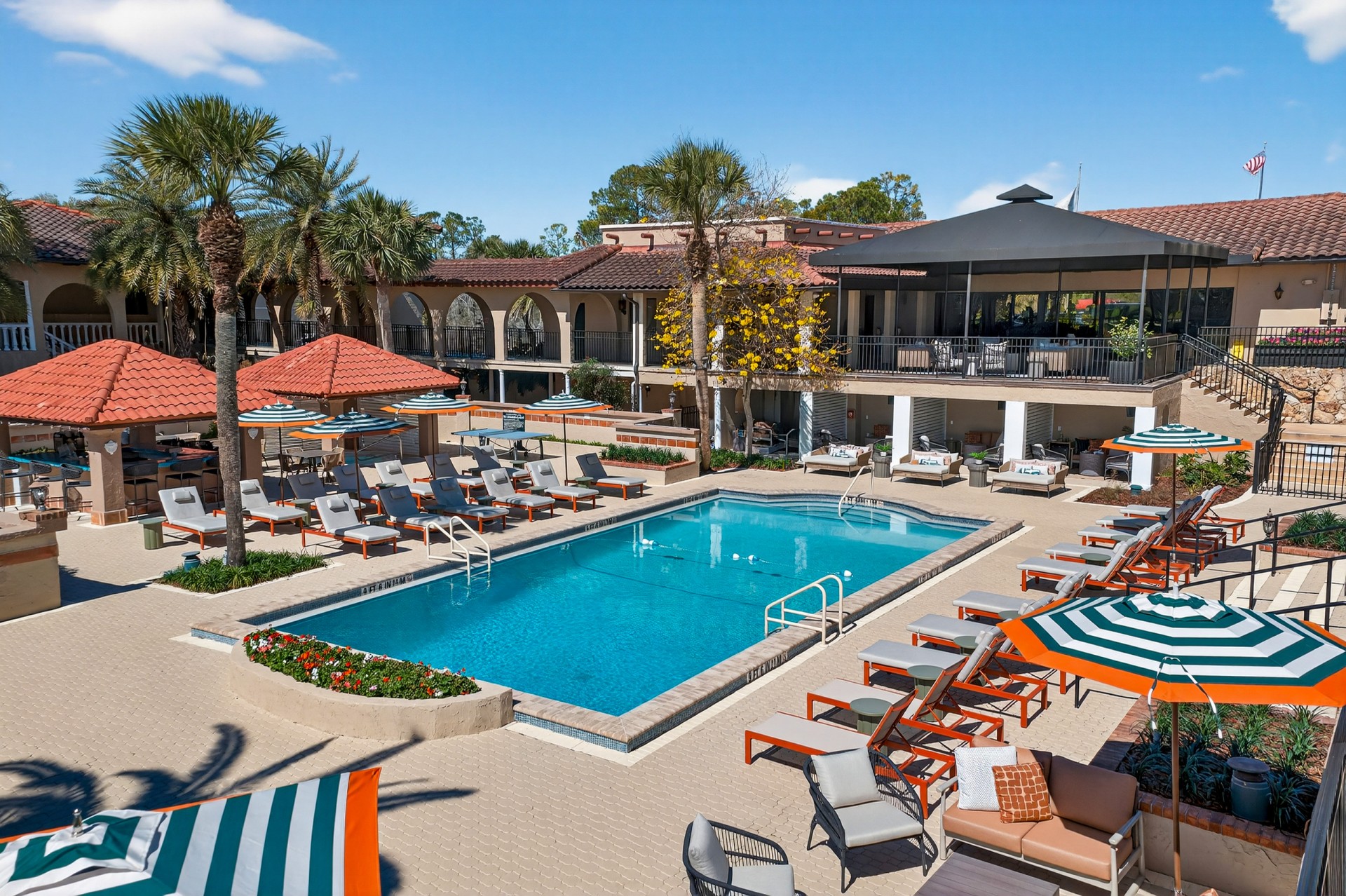a pool with lounge chairs and umbrellas