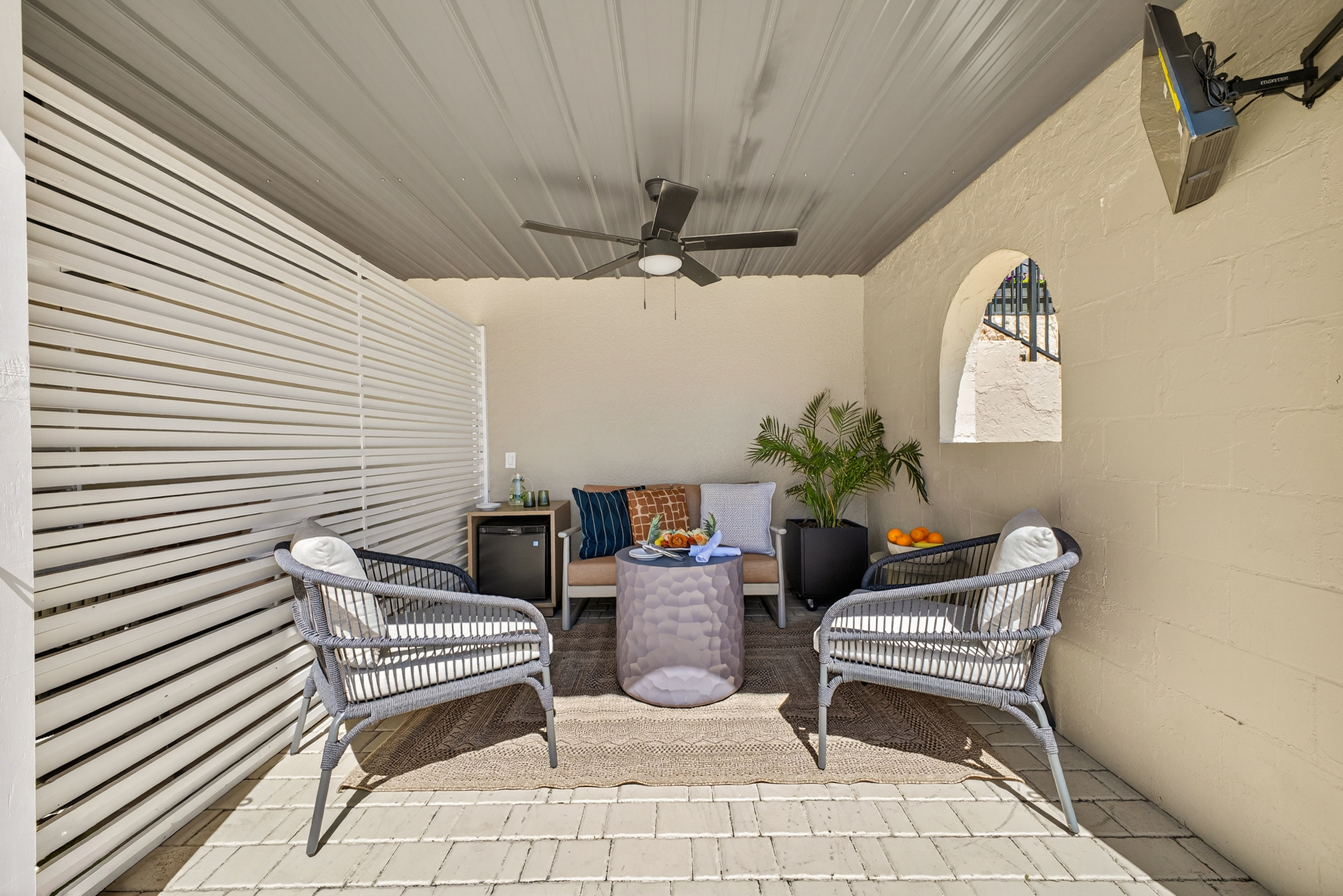 a patio with chairs and a table