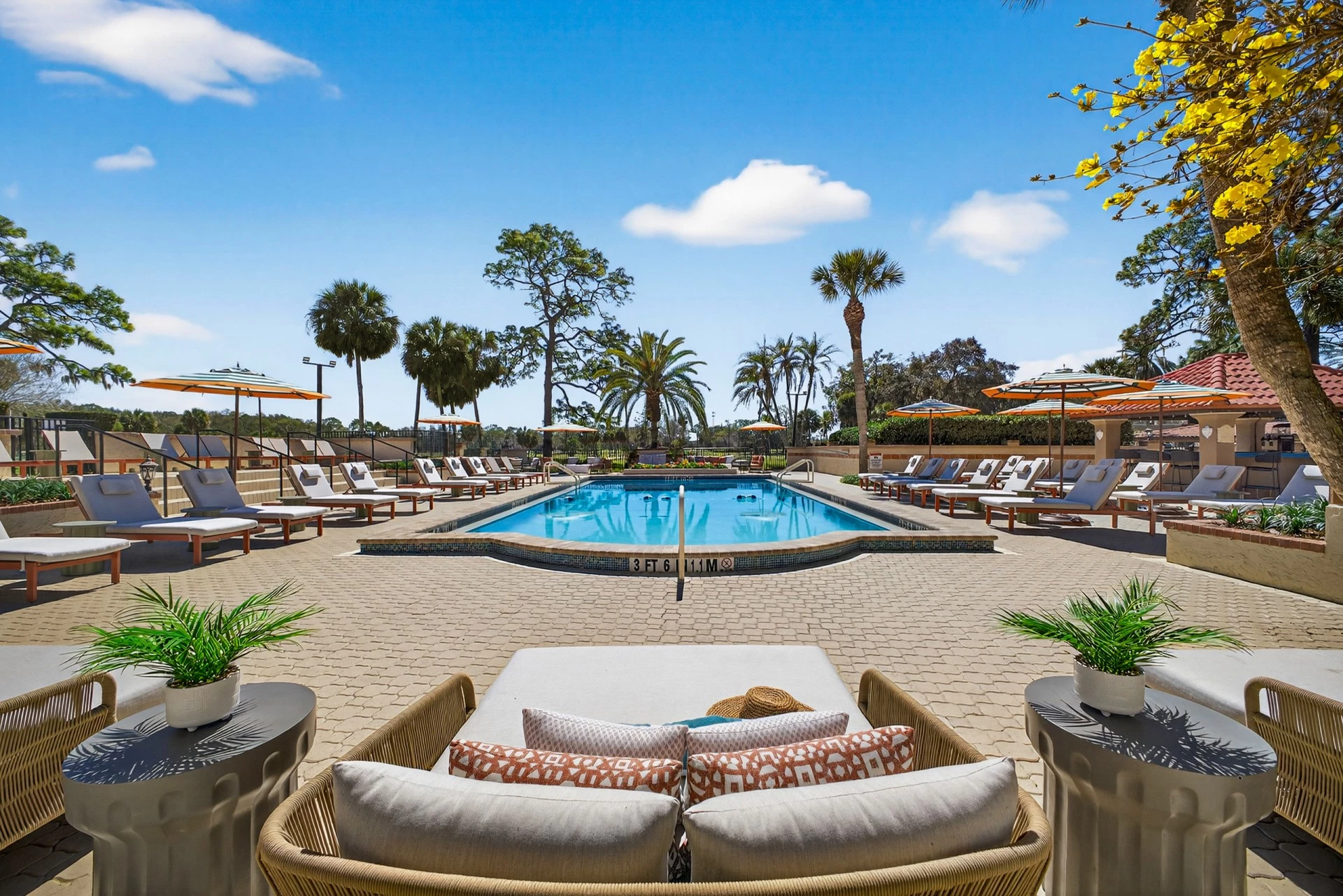 a pool with chairs and umbrellas
