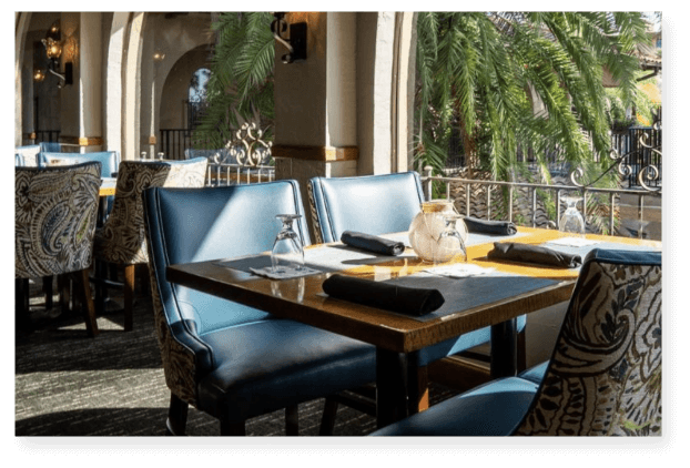 a table with chairs and a vase on it