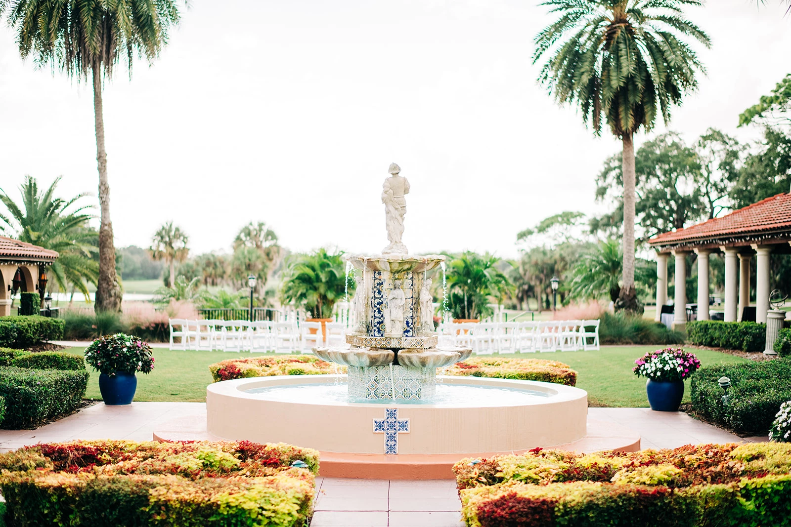 a fountain with a statue in the middle of a garden