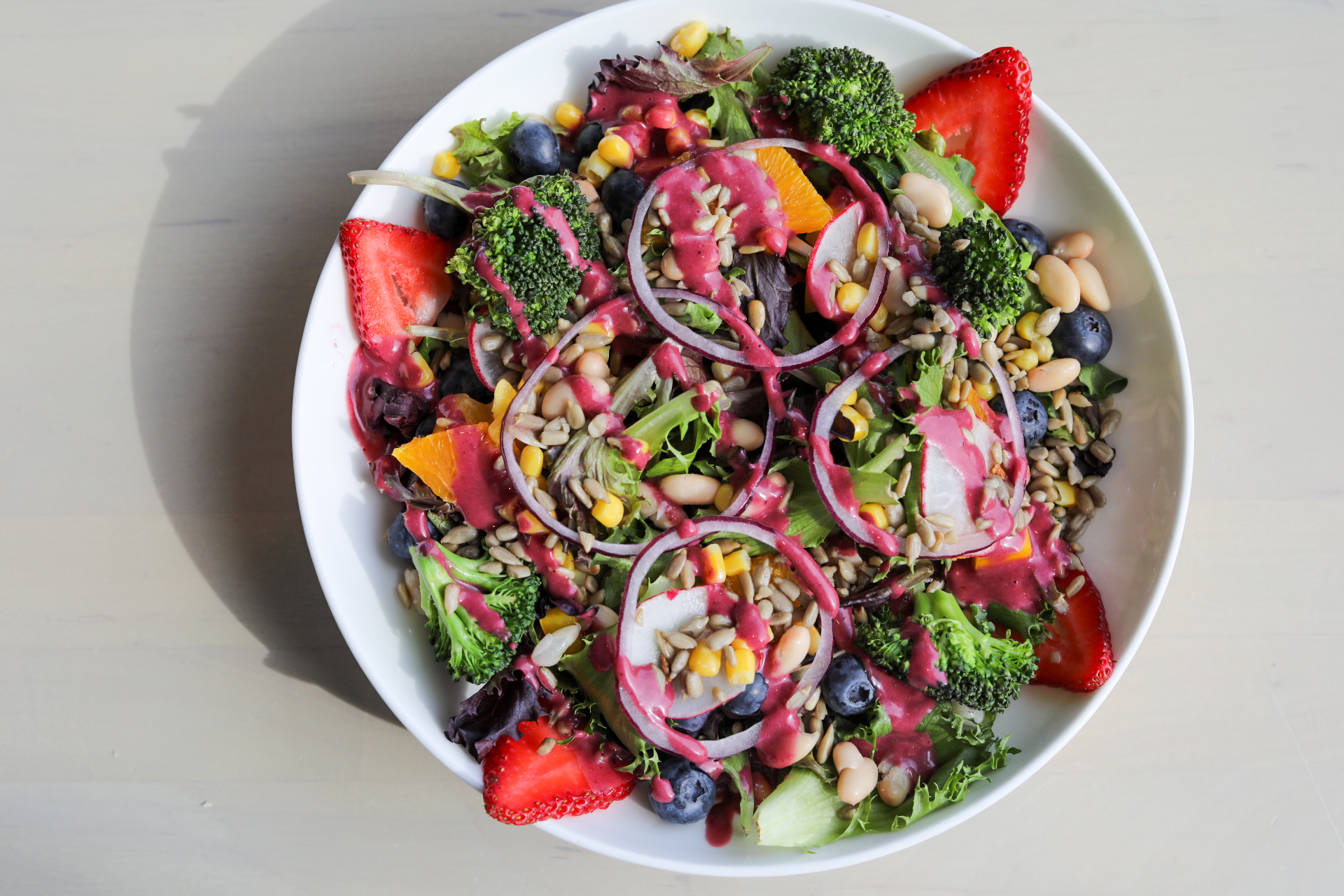 a bowl of salad with fruit and vegetables