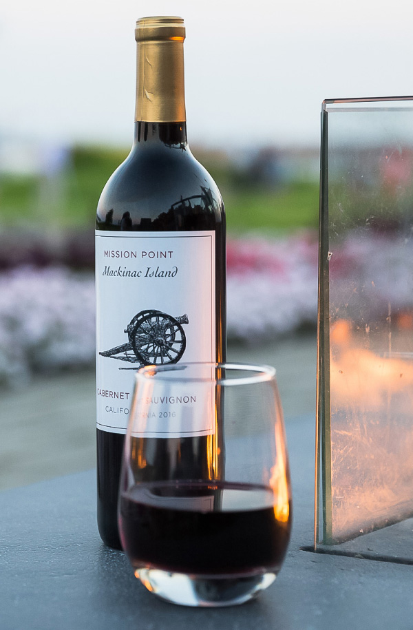 a bottle of wine next to a glass of wine