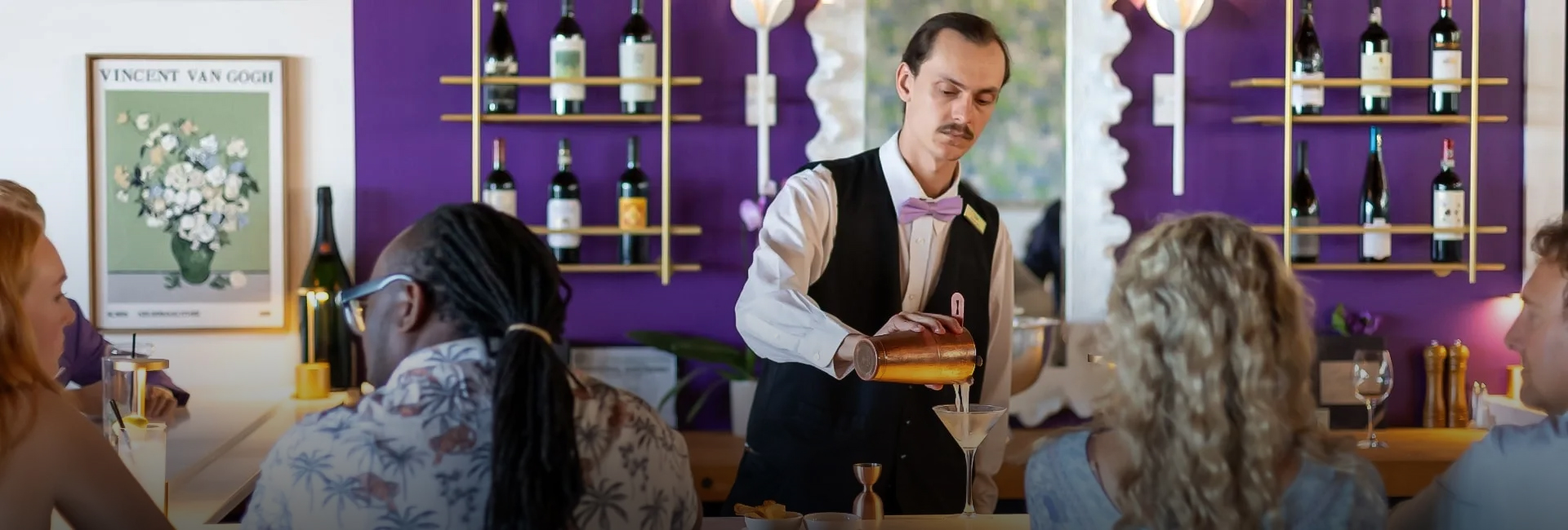 a man pouring a drink into a glass