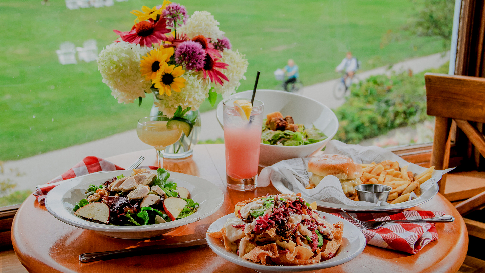 a table with plates of food and flowers