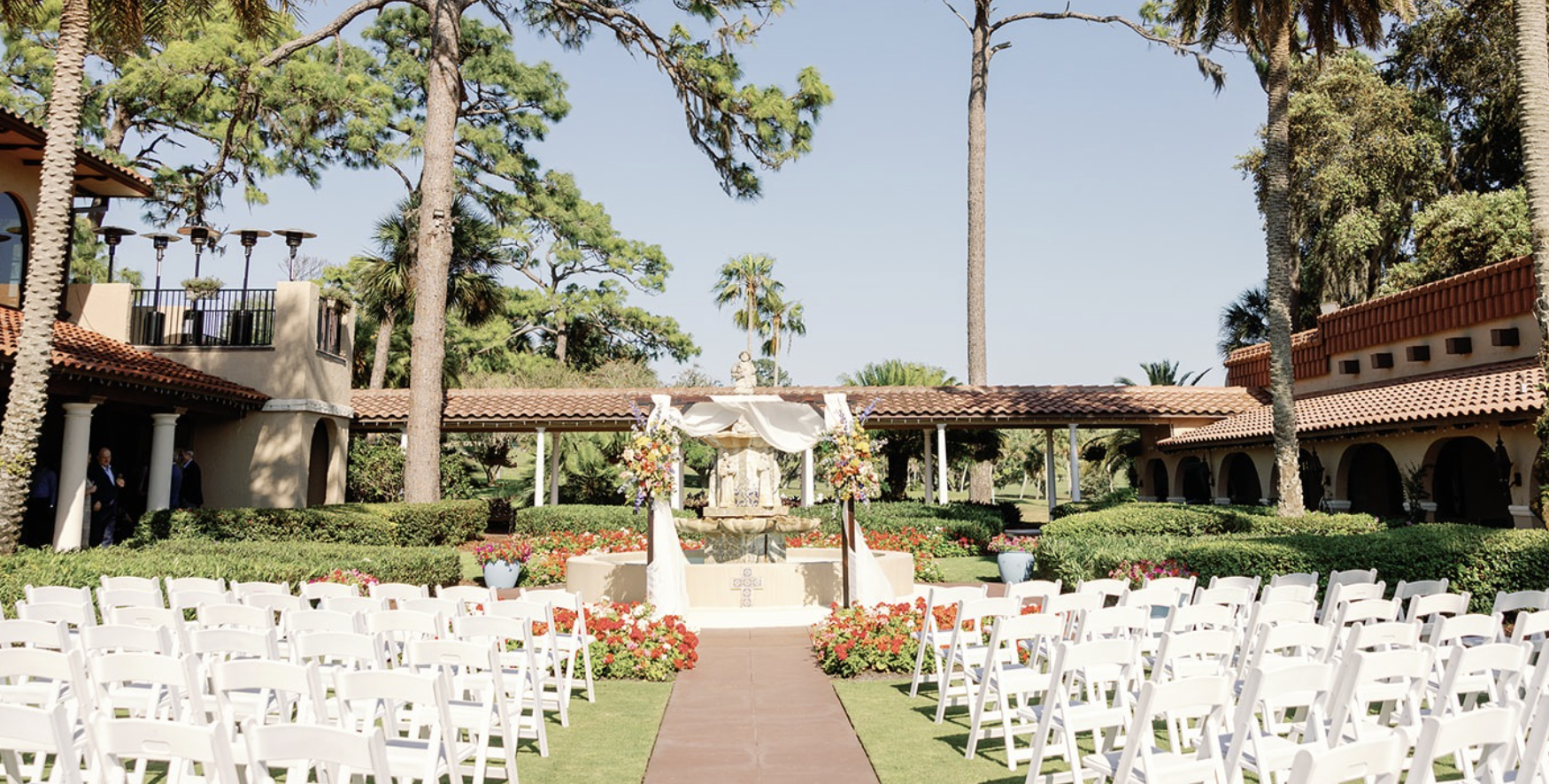 a wedding ceremony with chairs and flowers