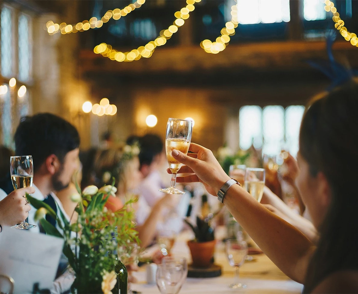 a group of people at a table holding champagne glasses