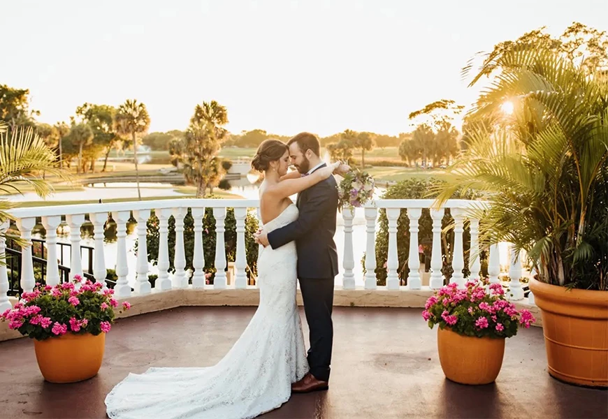 a man and woman kissing on a balcony