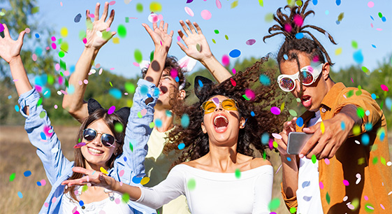 a group of people with confetti falling in the air