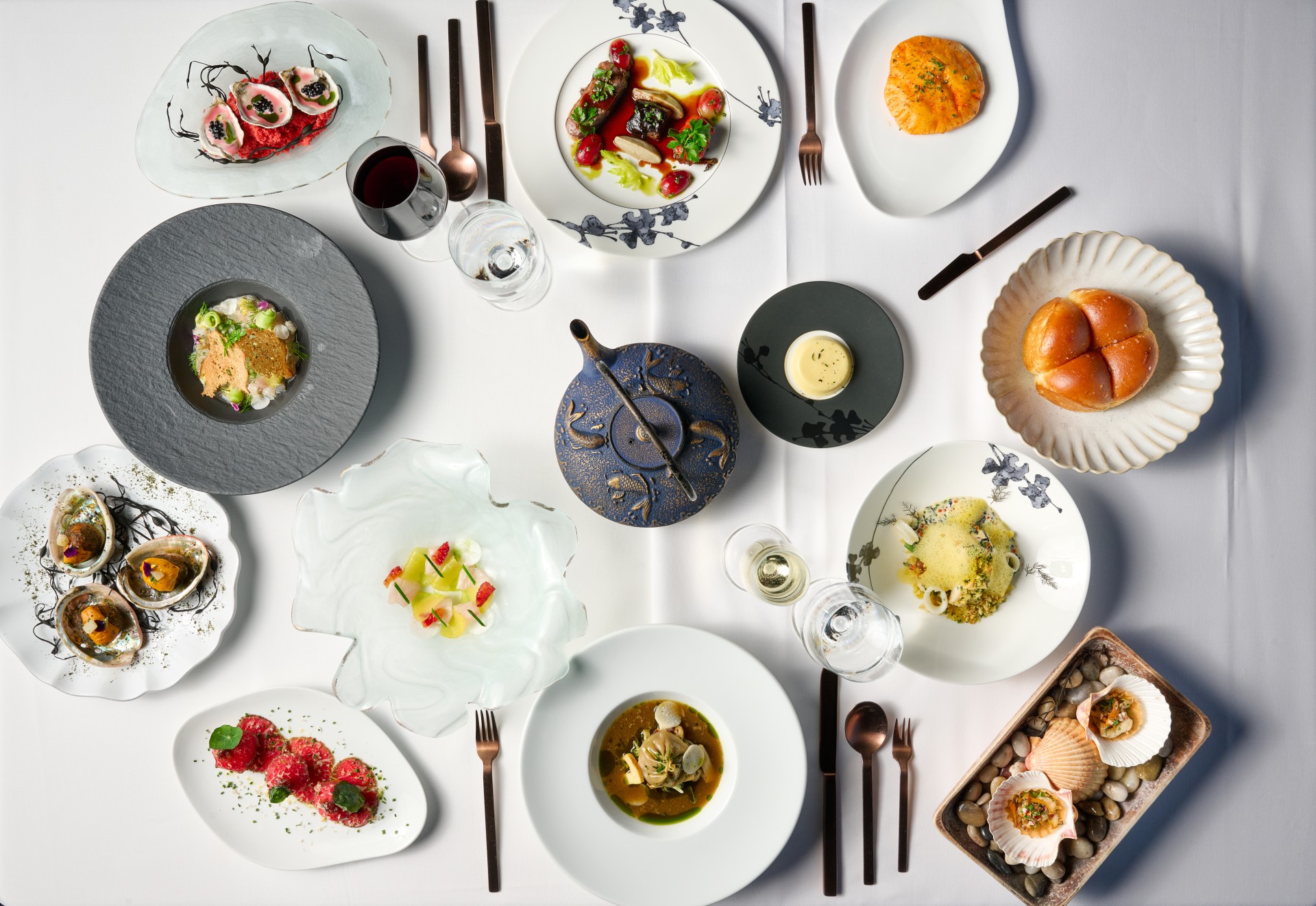 a table with plates of food and silverware