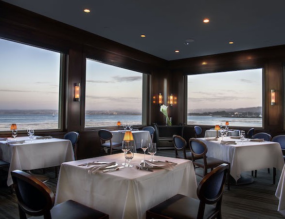 restaurant tables overlooking the bay at sunset