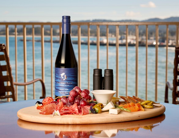 a wine bottle and a platter of food on a table