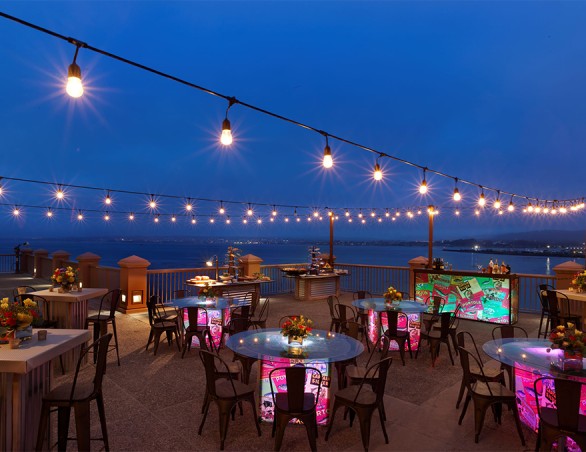 a restaurant with lights on the ceiling