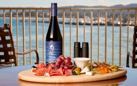 a wine bottle and a platter of food