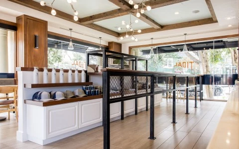 a room with a black railing and shelves with hats