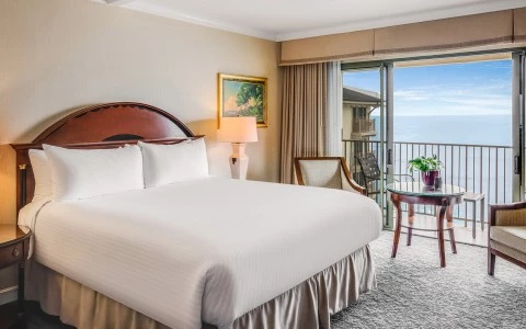 a hotel room with a large bed and a table and chairs