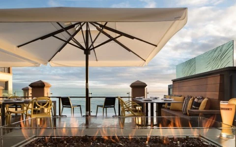 a table and chairs under a fire pit