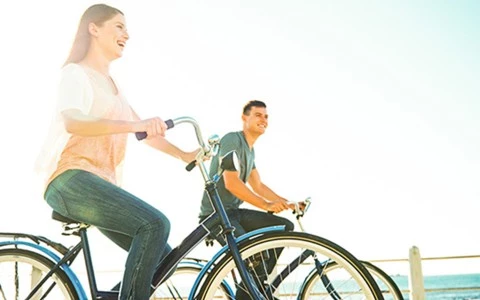 a man and woman riding bicycles