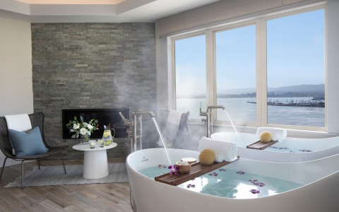 a bathtub with hot water in the middle of the room