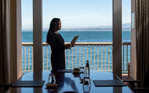 a woman standing on a balcony looking out a window