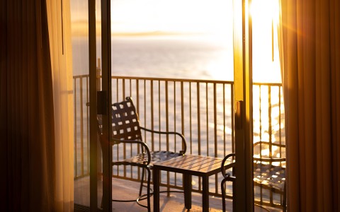 a chair and table on a balcony
